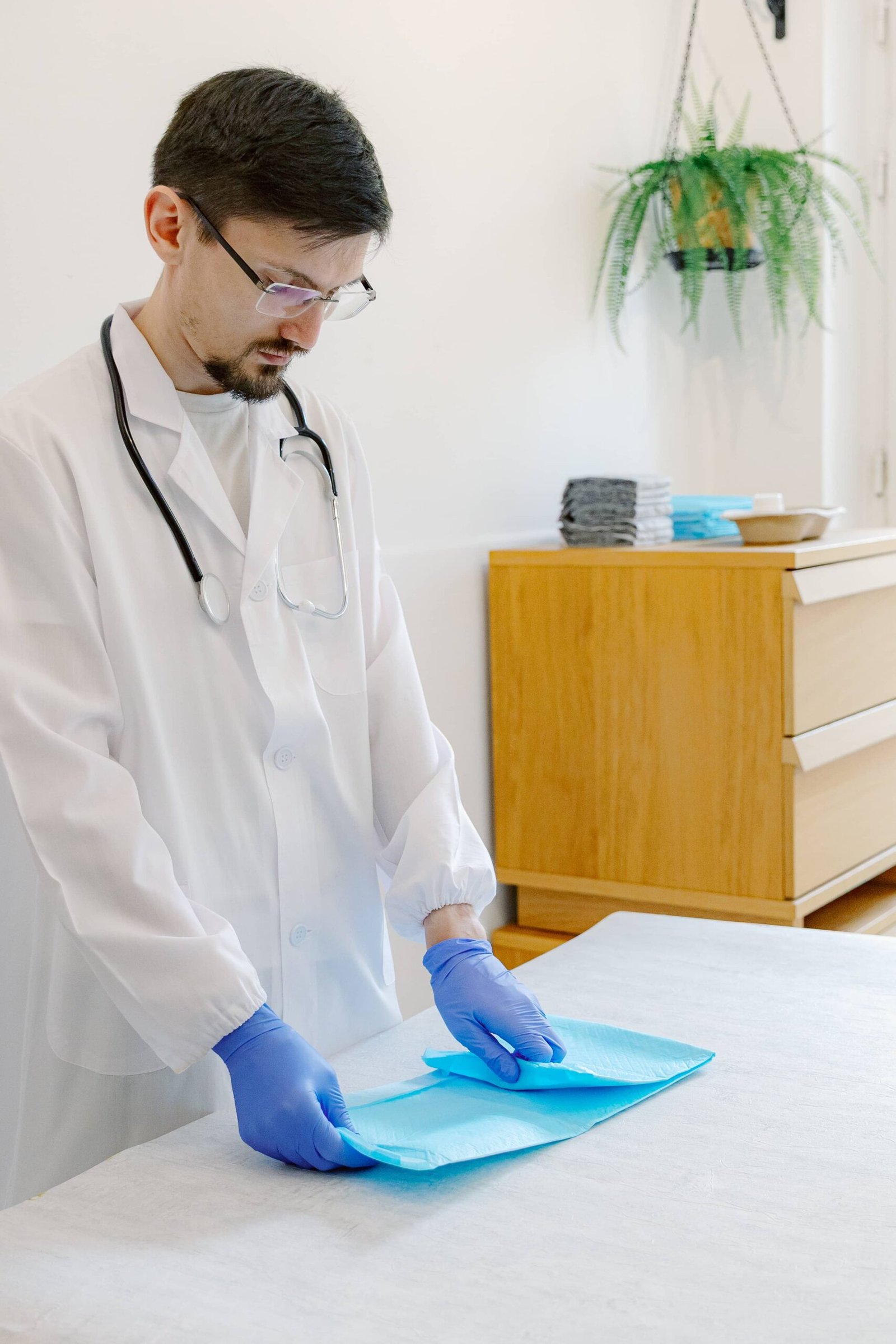 青い布でペットエリア付近の床を掃除する人