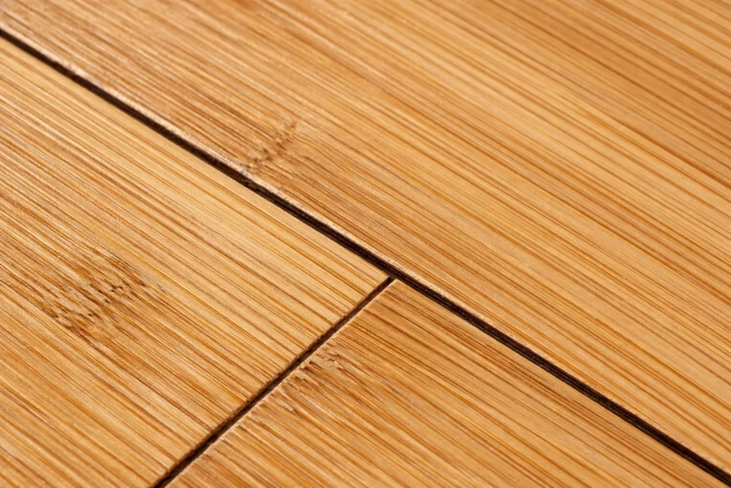 Close view of bamboo floor seams being checked for hidden pet urine damage